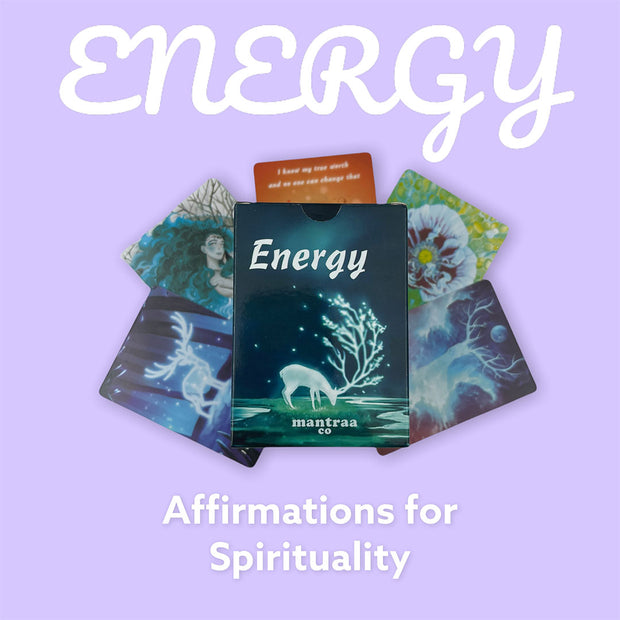 Energy affirmation cards for spirituality. Mantraa Co affirmation deck on top of affirmation cards with a purple background.